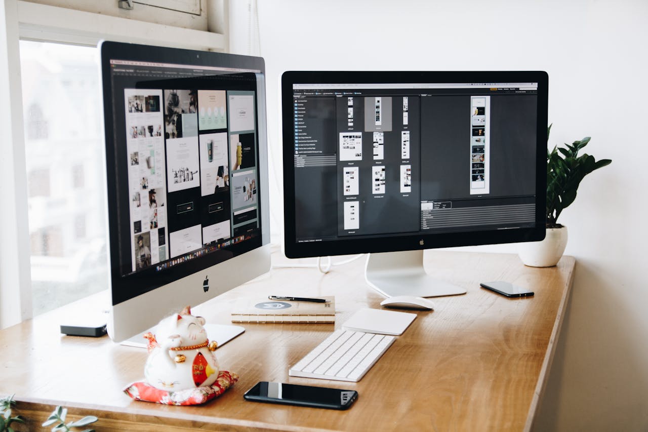 about-02 A well-organized design workspace with dual monitors and design software on display.